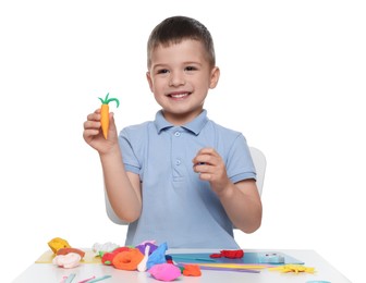 Smiling boy showing carrot made from play dough on white background