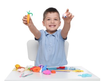 Photo of Smiling boy showing carrot and ball made from play dough on white background