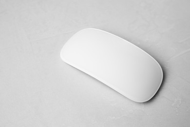One wireless mouse on light textured table, closeup. Space for text