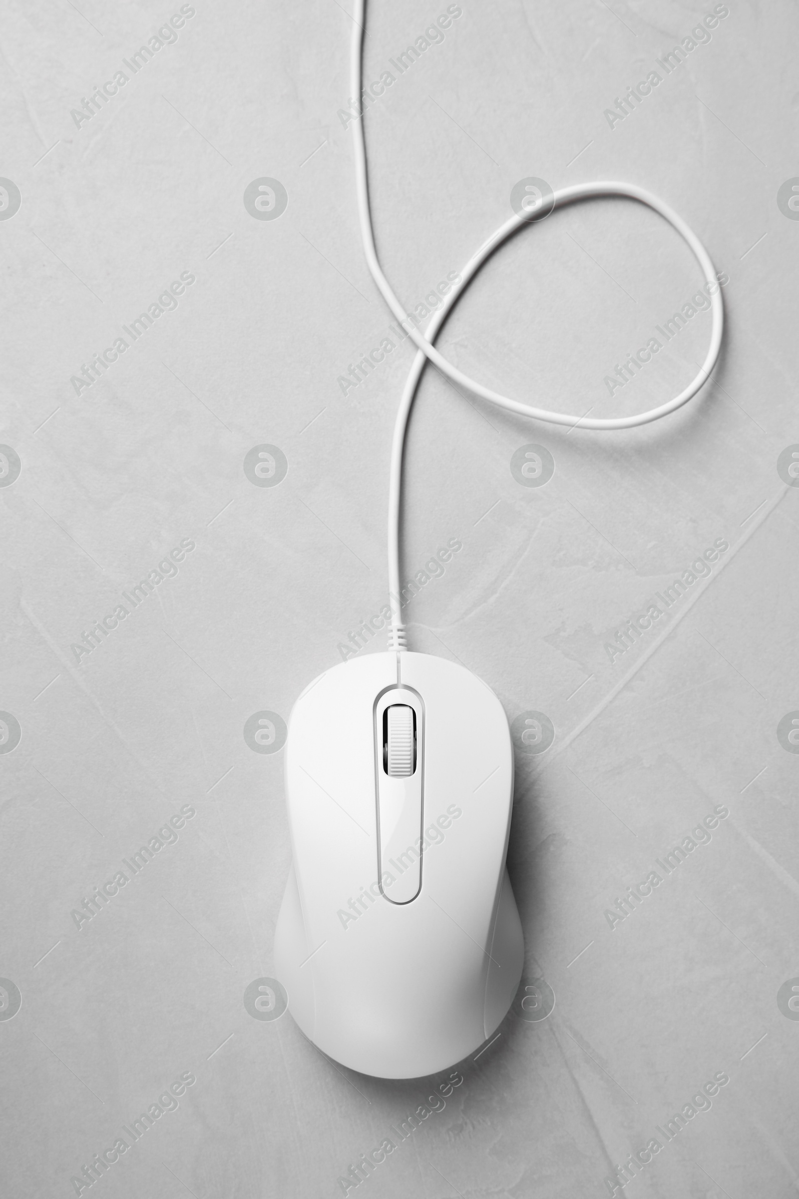 Photo of One wired mouse on grey textured table, top view