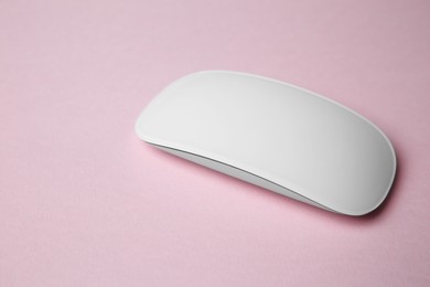 Photo of One wireless mouse on pink background. Space for text