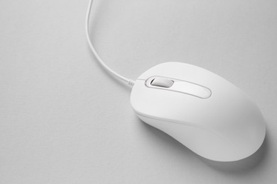One wired mouse on grey background, closeup. Space for text