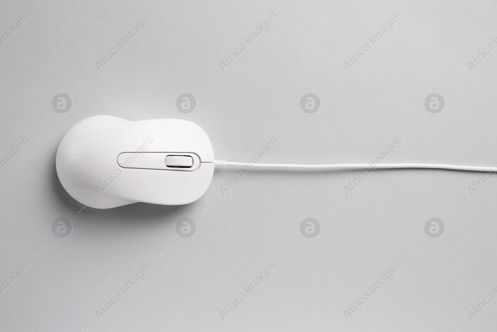 Photo of One wired mouse on grey background, top view