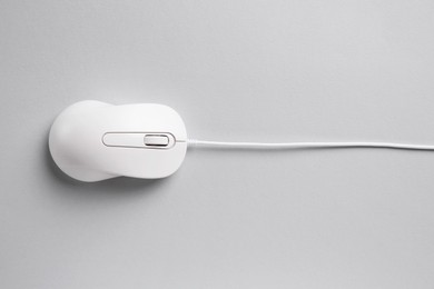 One wired mouse on grey background, top view