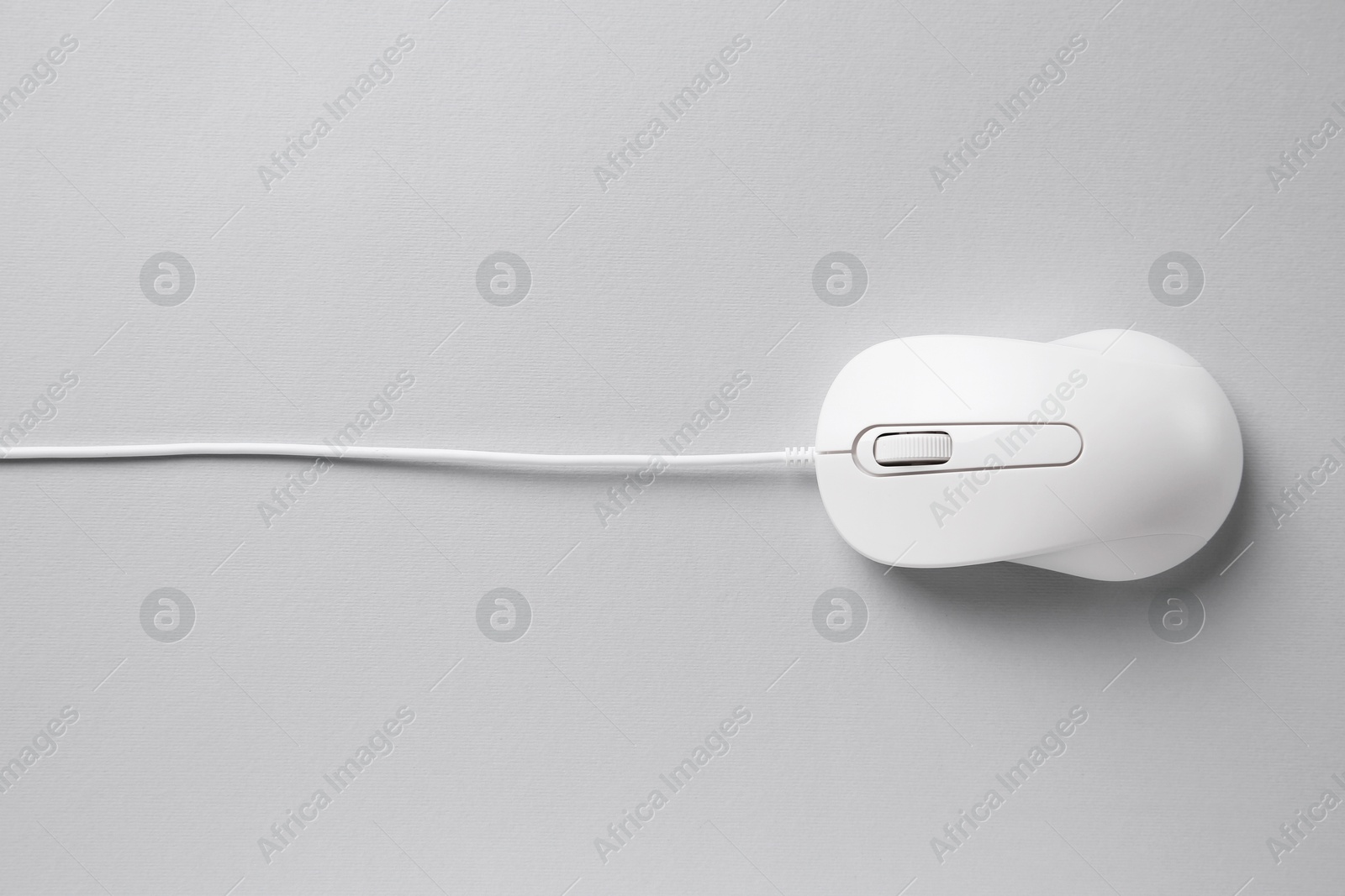 Photo of One wired mouse on grey background, top view