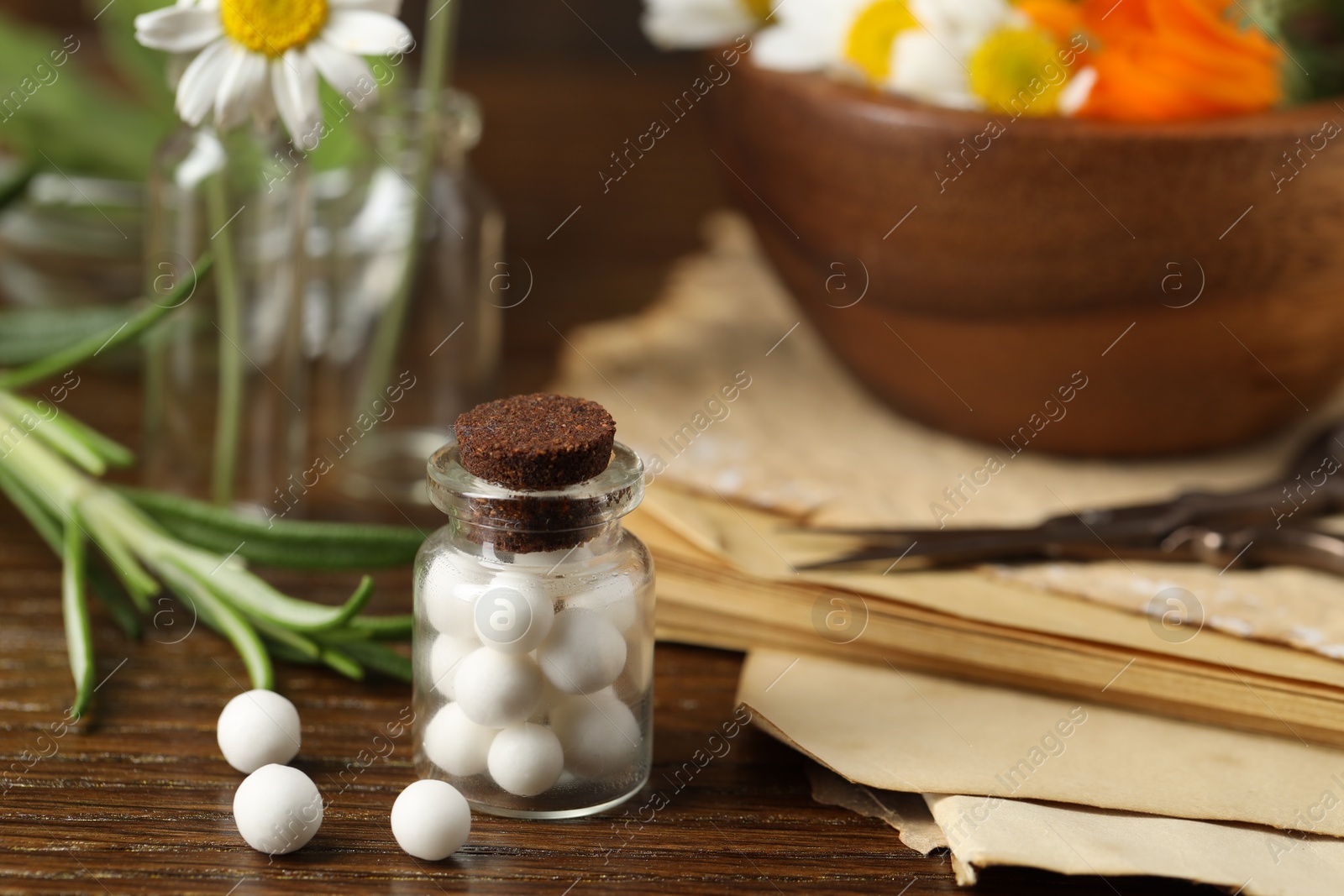 Photo of Homeopathy. Glass bottle with pills on wooden table, closeup