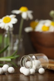 Homeopathy. Glass bottle with pills on wooden table, closeup