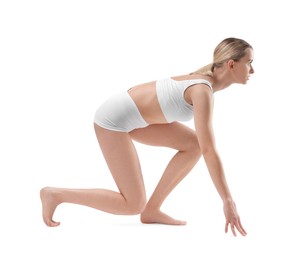Photo of Sporty woman in starting position for run on white background