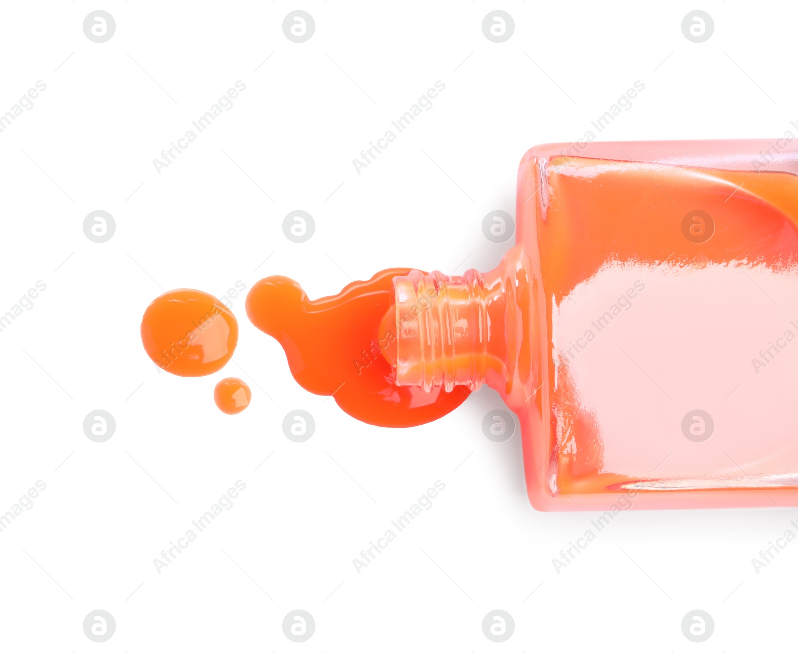 Photo of Bottle and spilled orange nail polish isolated on white, top view