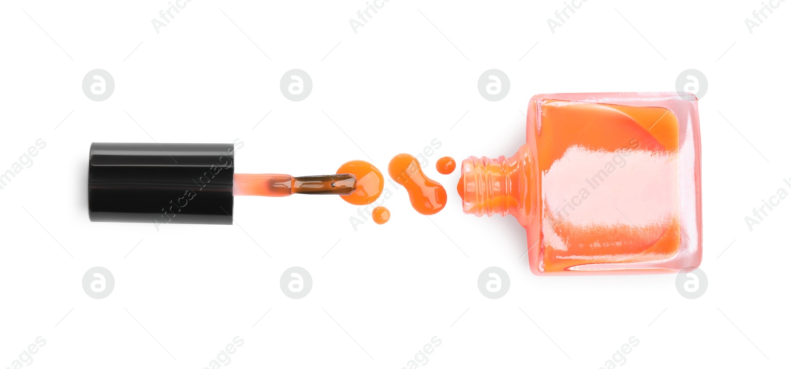 Photo of Bottle, brush and spilled orange nail polish isolated on white, top view