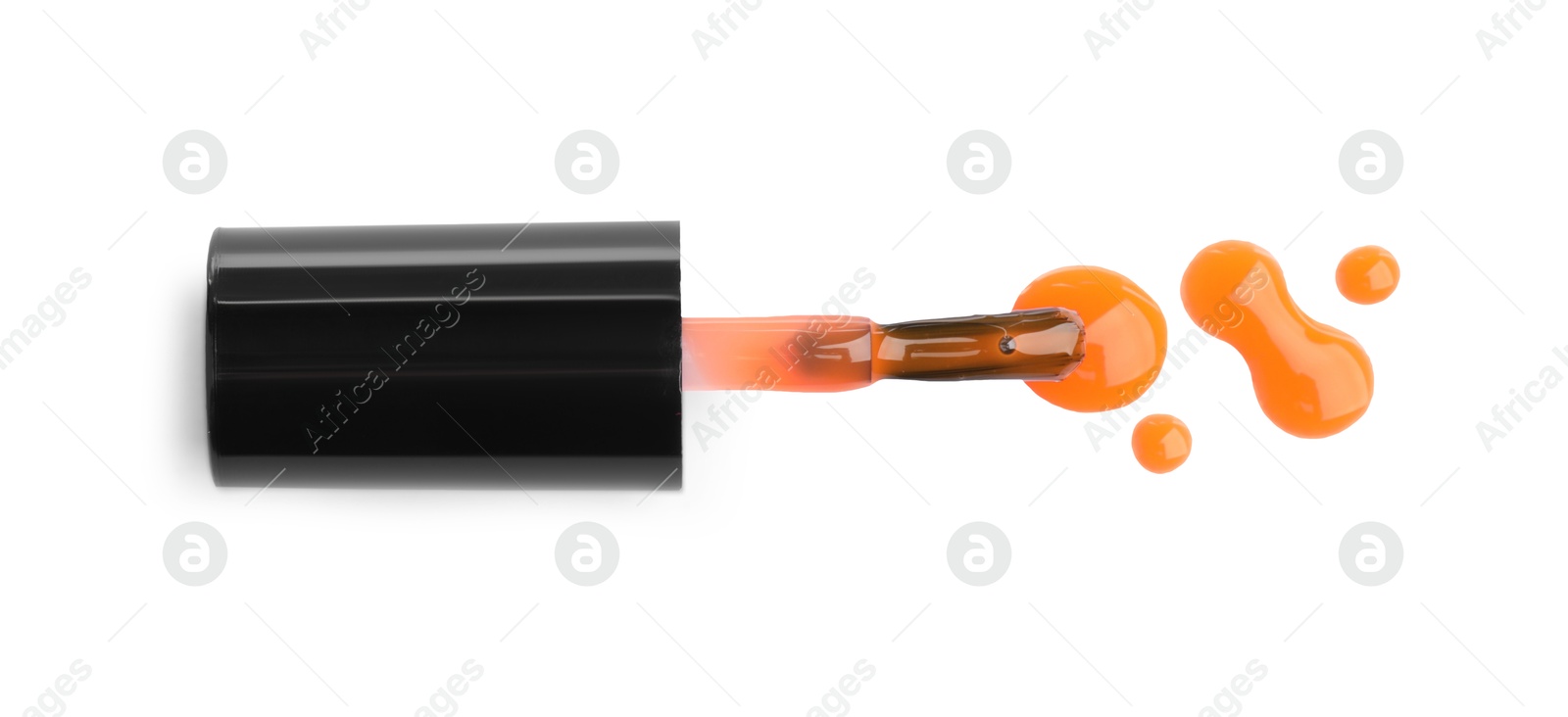 Photo of Brush and spilled orange nail polish isolated on white, top view