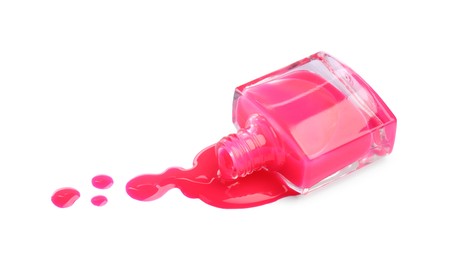 Photo of Bottle and spilled pink nail polish isolated on white