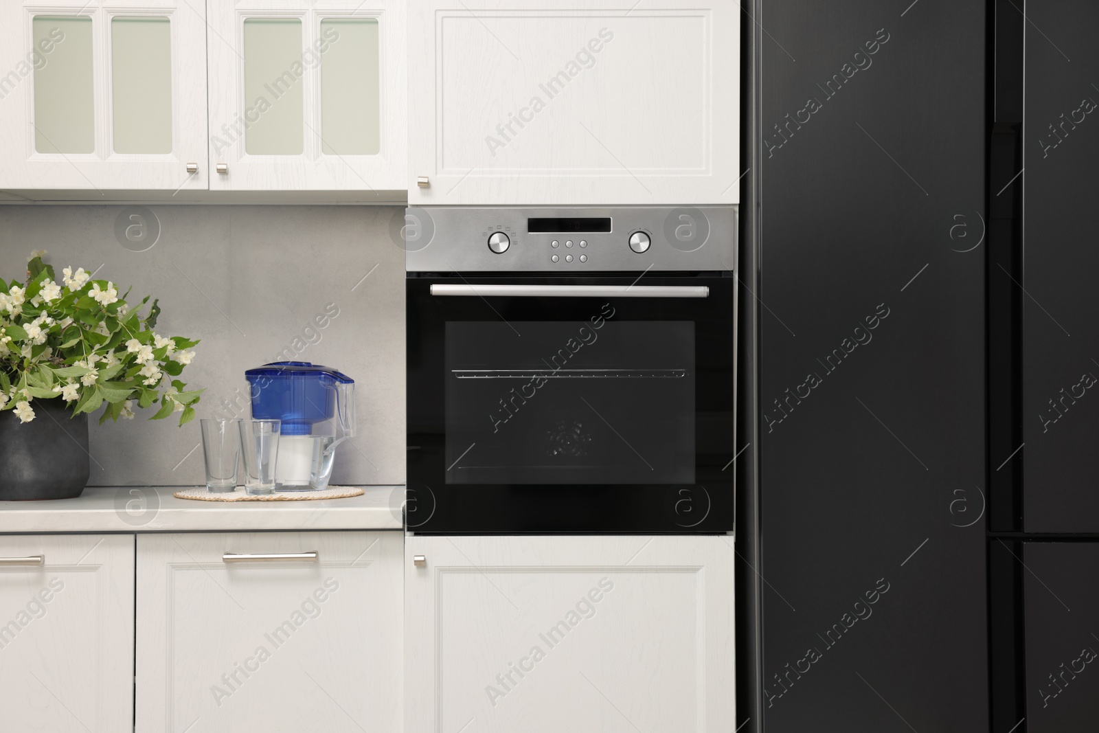 Photo of New electric oven in kitchen. Cooking appliance