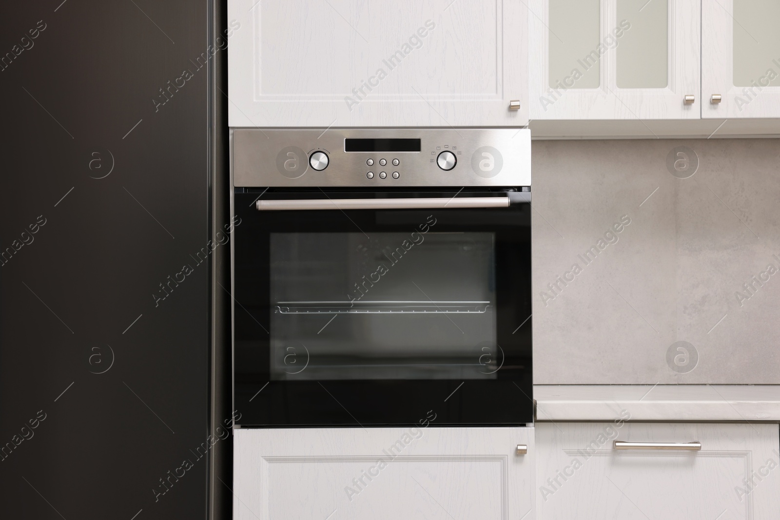 Photo of New electric oven in kitchen. Cooking appliance