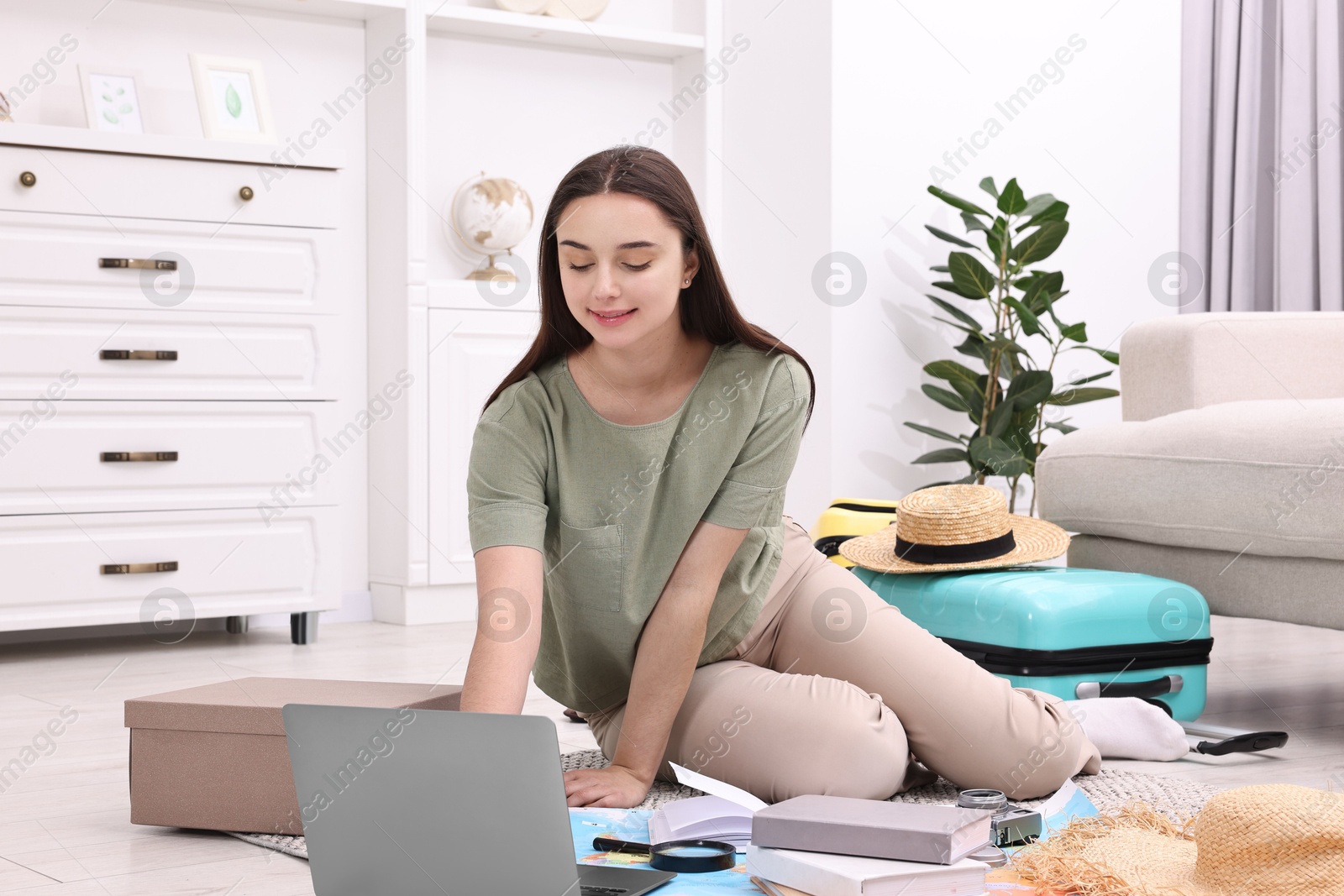 Photo of Travel blogger using laptop for planning trip at home