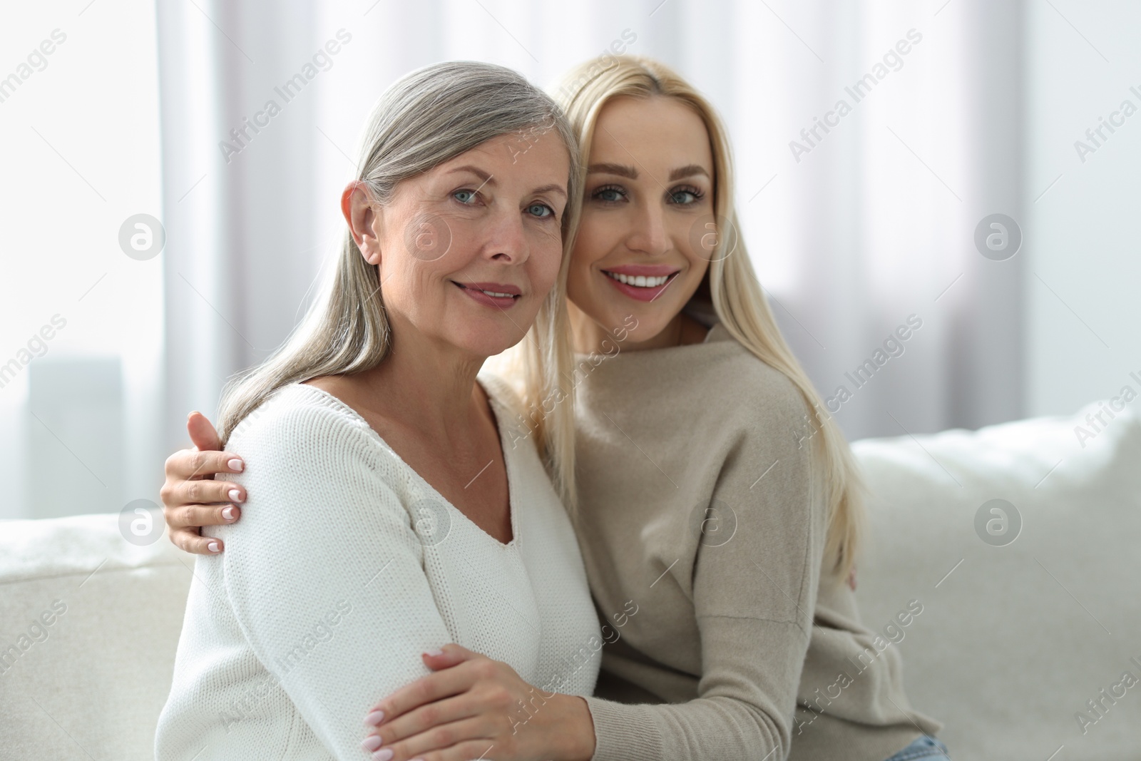 Photo of Family portrait of young woman and her mother at home