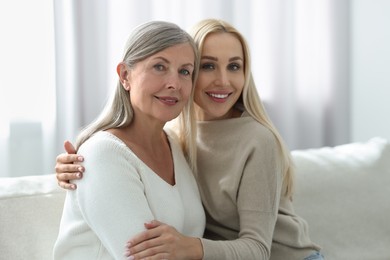 Photo of Family portrait of young woman and her mother at home