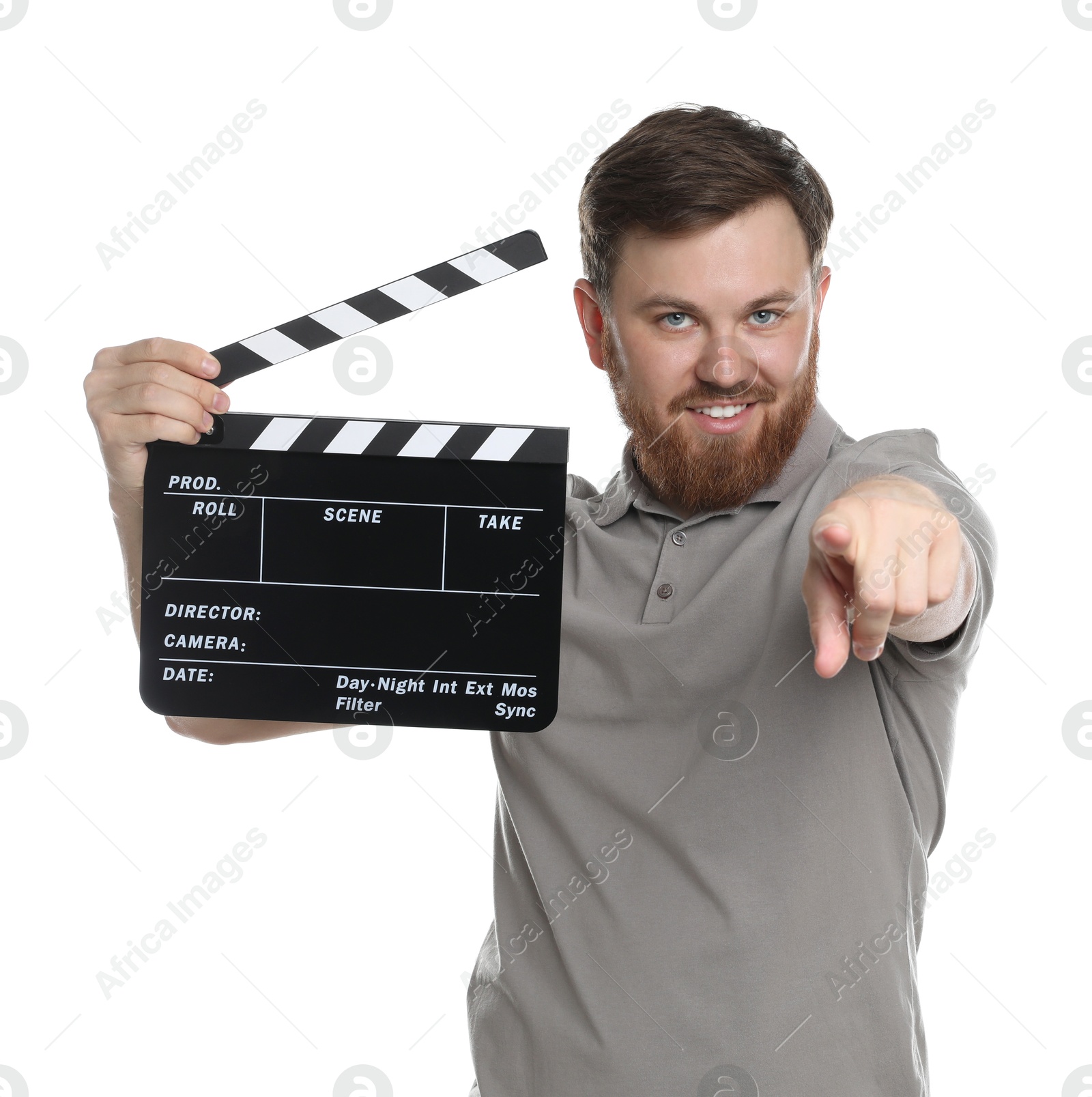 Photo of Making movie. Smiling man with clapperboard pointing at camera on white background