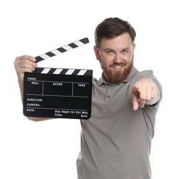 Photo of Making movie. Smiling man with clapperboard pointing at camera on white background