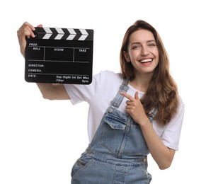 Making movie. Smiling woman pointing at clapperboard on white background