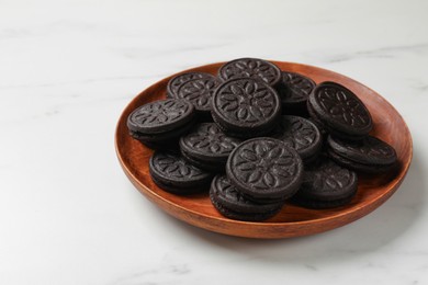 Plate with tasty sandwich cookies on white marble table, closeup. Space for text