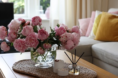 Photo of Beautiful pink peonies in vase on table at home. Interior design