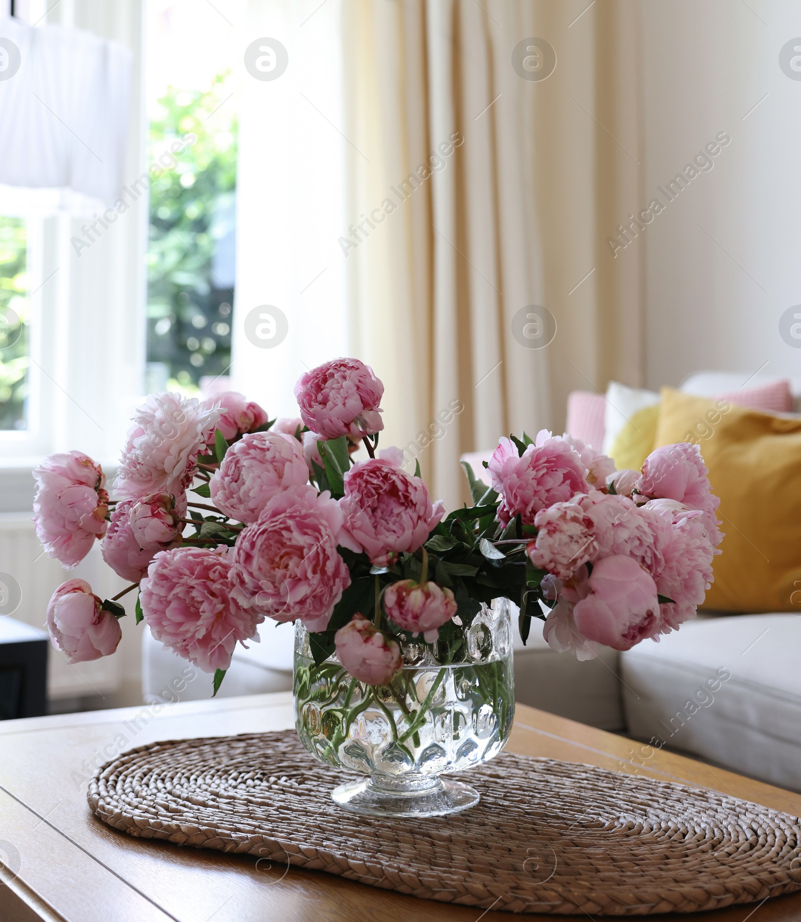 Photo of Beautiful pink peonies in vase on table at home, space for text. Interior design