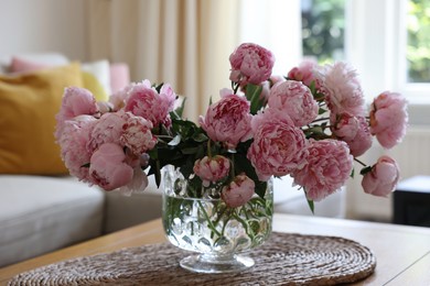 Photo of Beautiful pink peonies in vase on table at home. Interior design