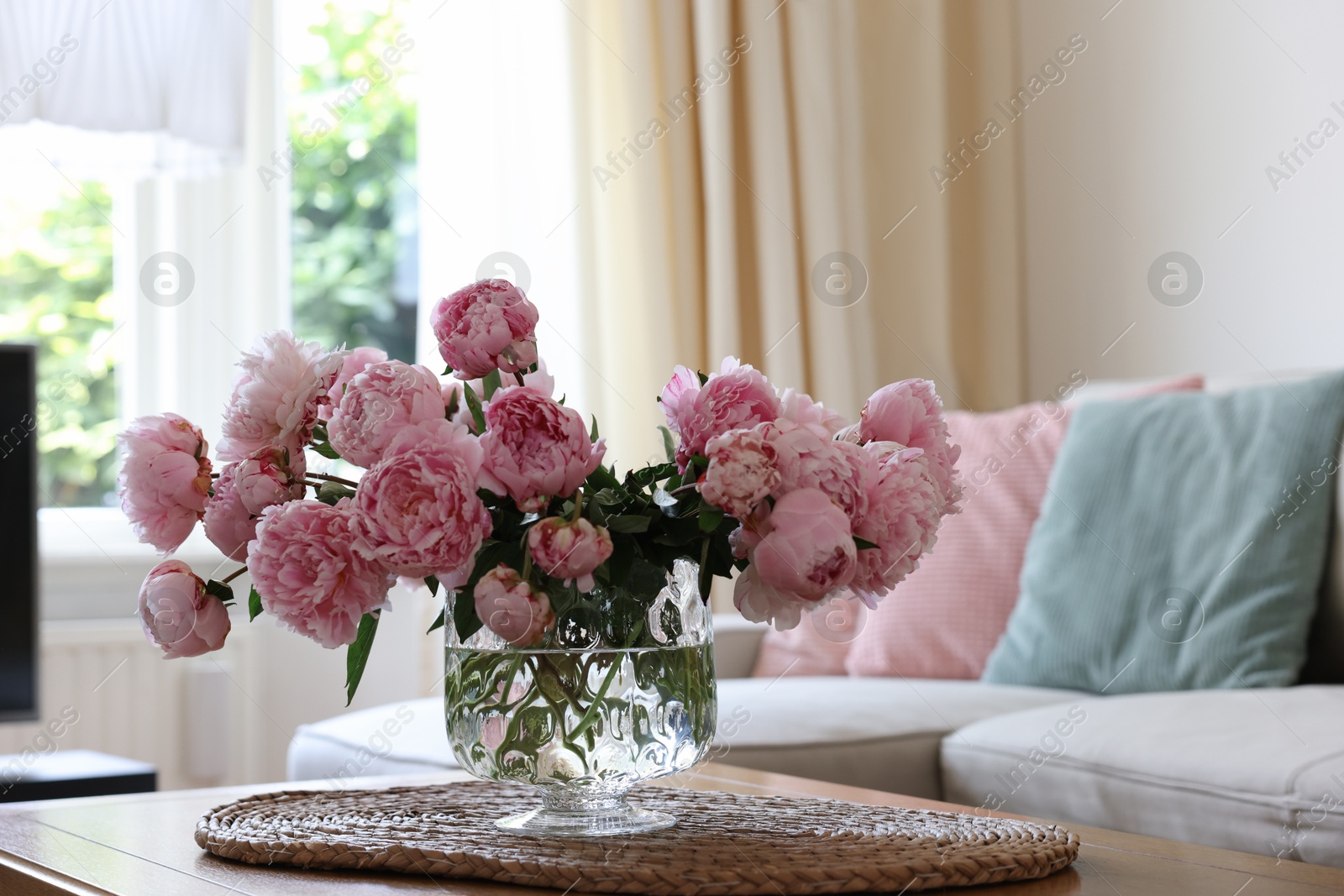 Photo of Beautiful pink peonies in vase on table at home, space for text. Interior design