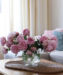 Photo of Beautiful pink peonies in vase on table at home, space for text. Interior design