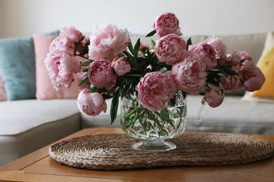 Beautiful pink peonies in vase on table at home. Interior design