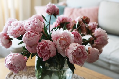 Beautiful pink peonies in vase on table at home, closeup. Interior design