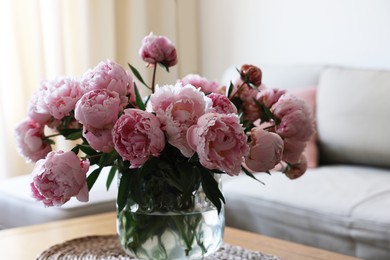 Beautiful pink peonies in vase on table at home. Interior design