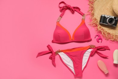 Photo of Flat lay composition with beautiful swimsuit on pink background. Space for text