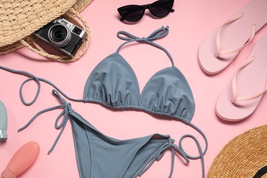 Photo of Flat lay composition with beautiful swimsuit on pink background