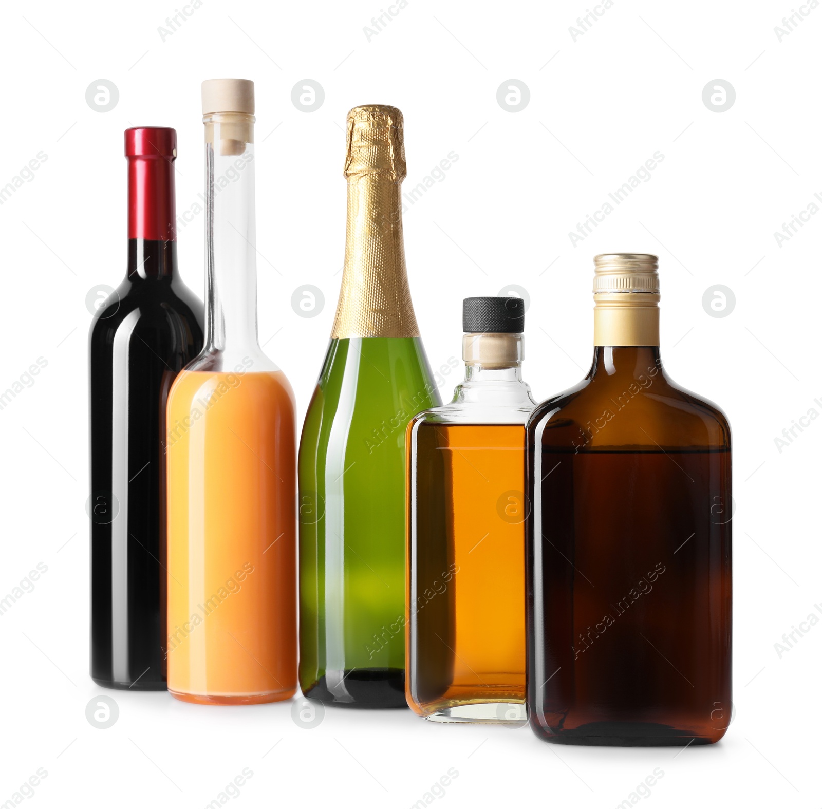 Photo of Bottles of different alcoholic drinks isolated on white