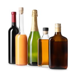 Photo of Bottles of different alcoholic drinks isolated on white