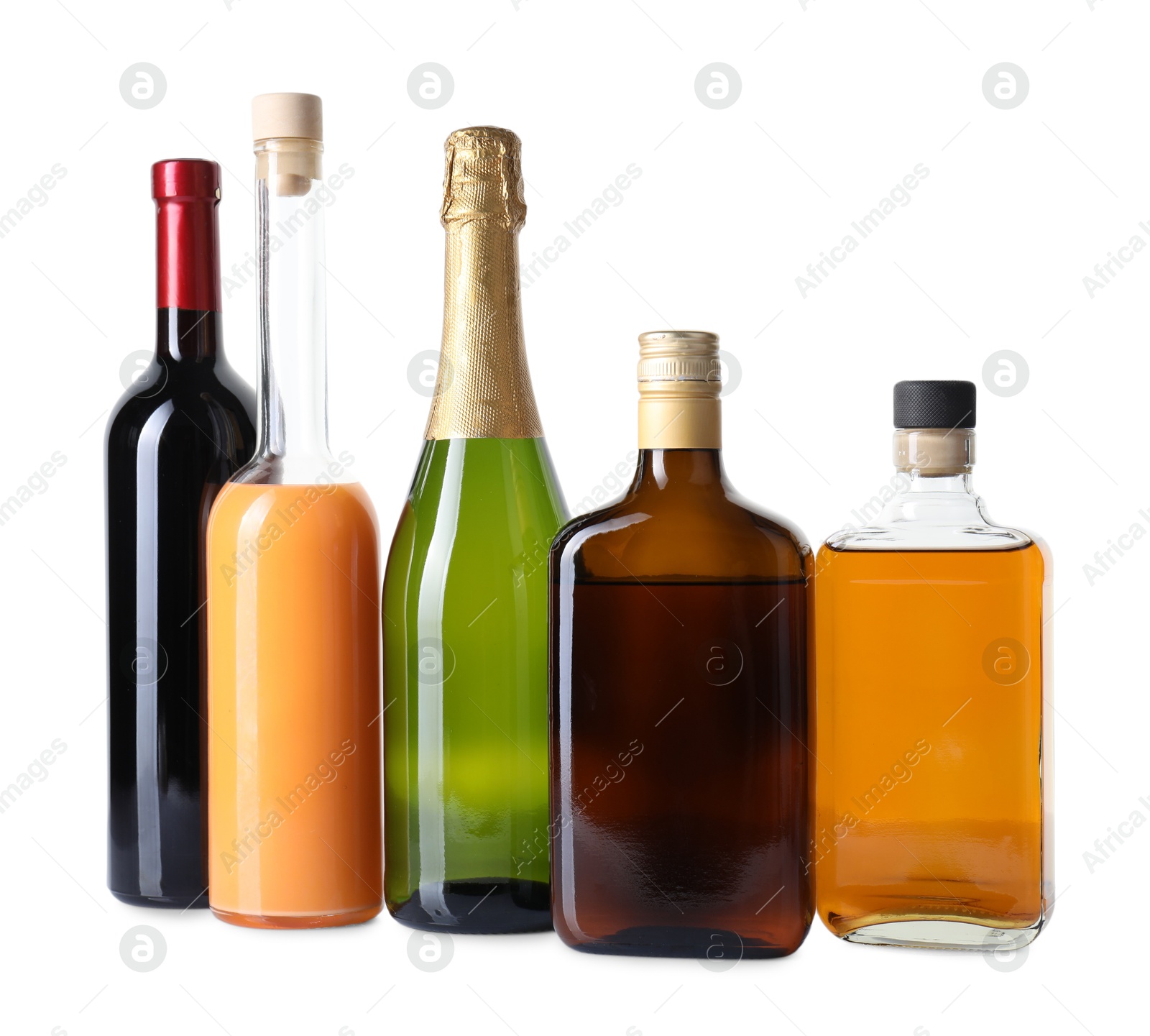 Photo of Bottles of different alcoholic drinks isolated on white