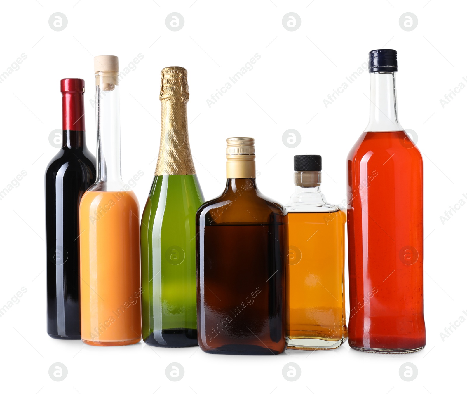 Photo of Bottles of different alcoholic drinks isolated on white