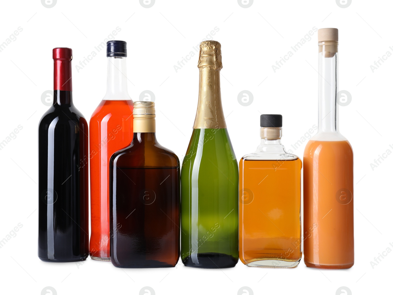 Photo of Bottles of different alcoholic drinks isolated on white