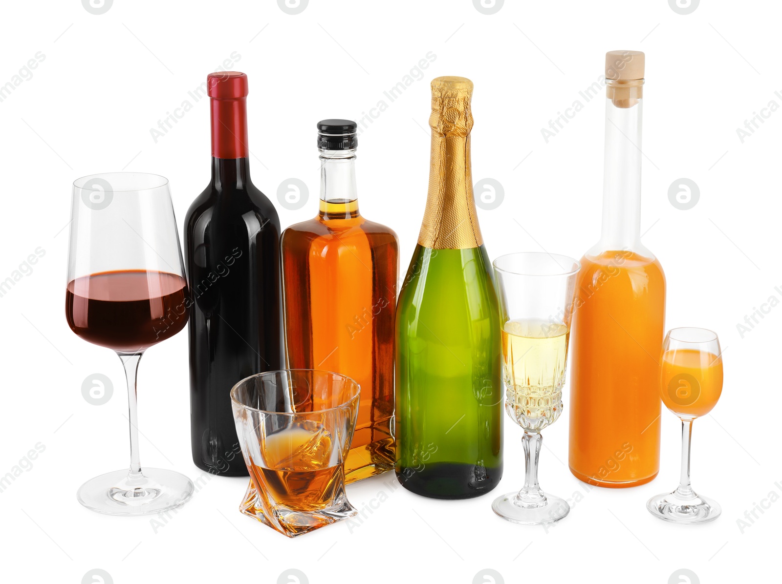 Photo of Bottles and glasses with different alcoholic drinks isolated on white