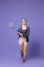 Photo of Young woman with badminton racket on purple background