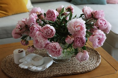 Beautiful pink peonies in vase on table at home. Interior design