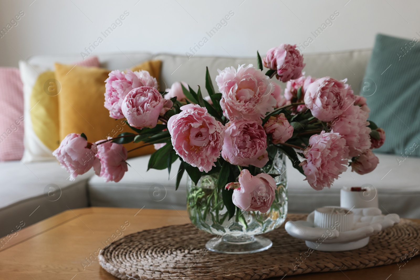 Photo of Beautiful pink peonies in vase on table at home. Interior design