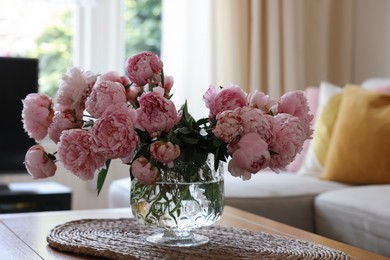 Photo of Beautiful pink peonies in vase on table at home. Interior design