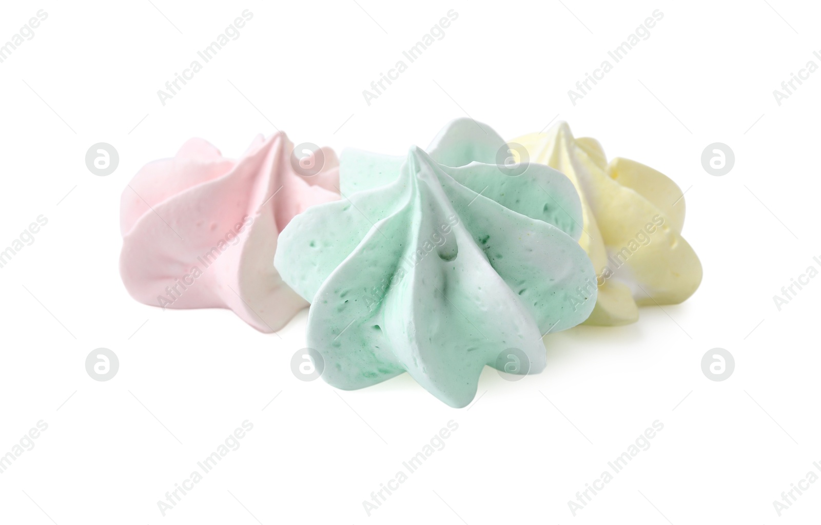 Photo of Three delicious meringue cookies isolated on white