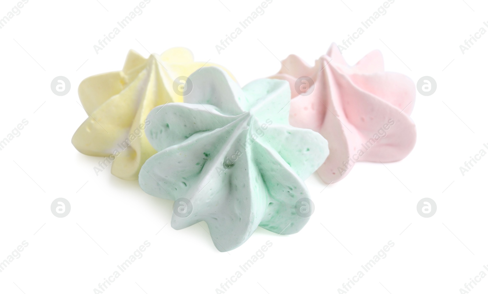 Photo of Three delicious meringue cookies isolated on white