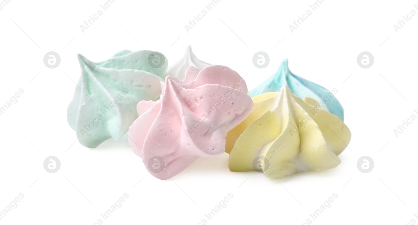 Photo of Many delicious meringue cookies isolated on white