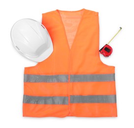 Photo of Orange reflective vest, hard hat and tape measure isolated on white, top view