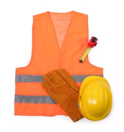 Photo of Orange reflective vest, hard hat, protective gloves and tape measure isolated on white, top view